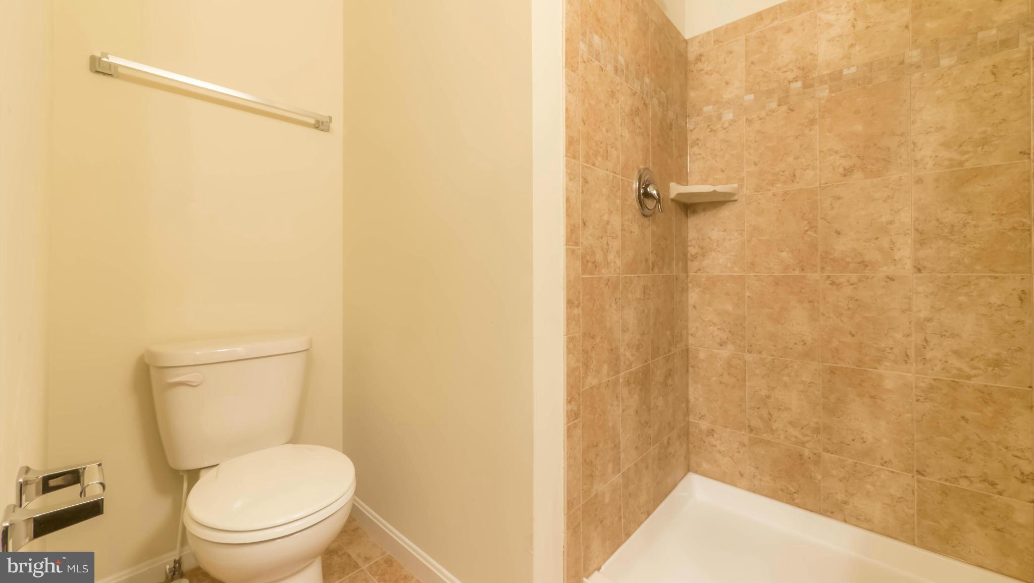 4628 Dillon Place Baltimore, MD 21224 - Photo 18 of 30 a white toilet sitting next to a shower
