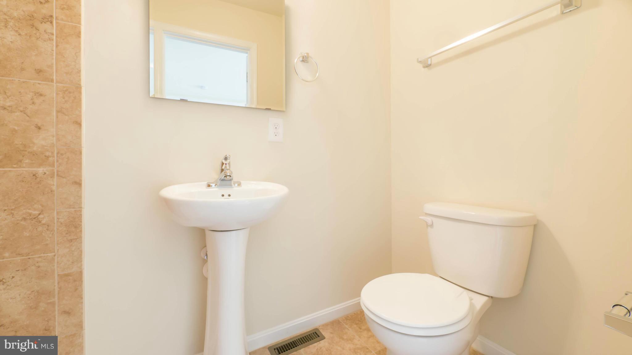 4628 Dillon Place Baltimore, MD 21224 - Photo 22 of 30 a white toilet sitting next to a white sink