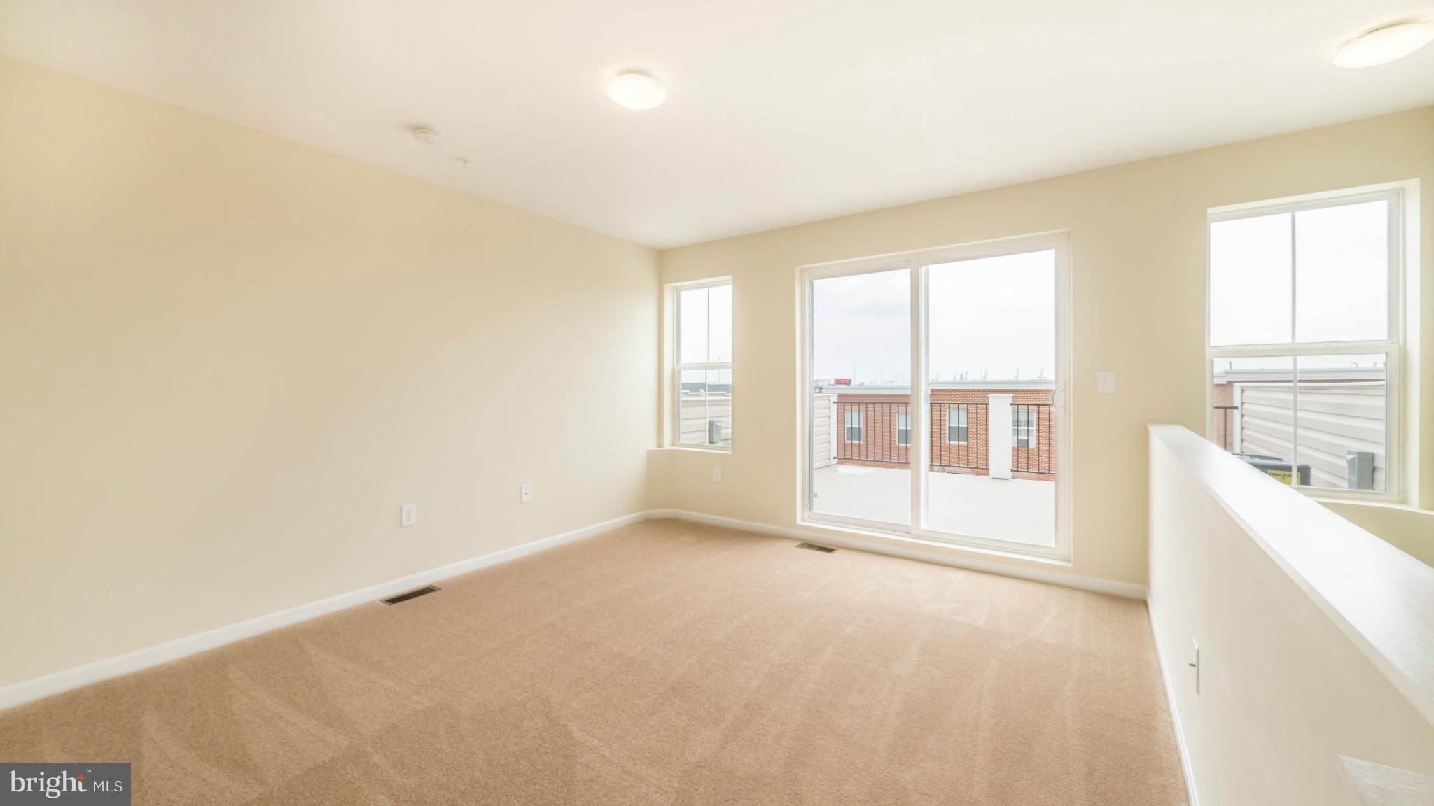 4628 Dillon Place Baltimore, MD 21224 - Photo 24 of 30 a big room with windows and chandelier fan