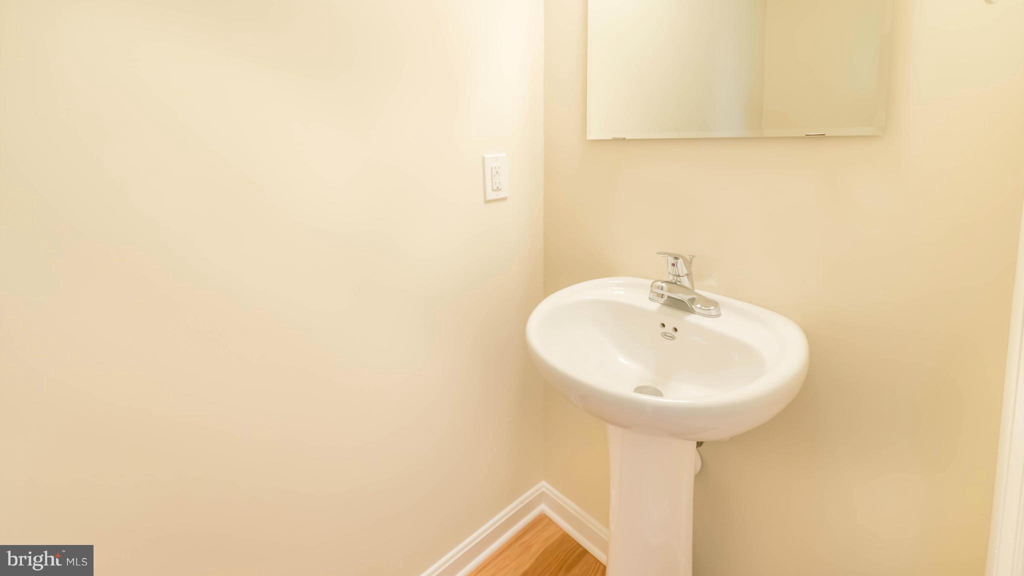 4628 Dillon Place Baltimore, MD 21224 - Photo 8 of 30 a bathroom with a sink and a mirror