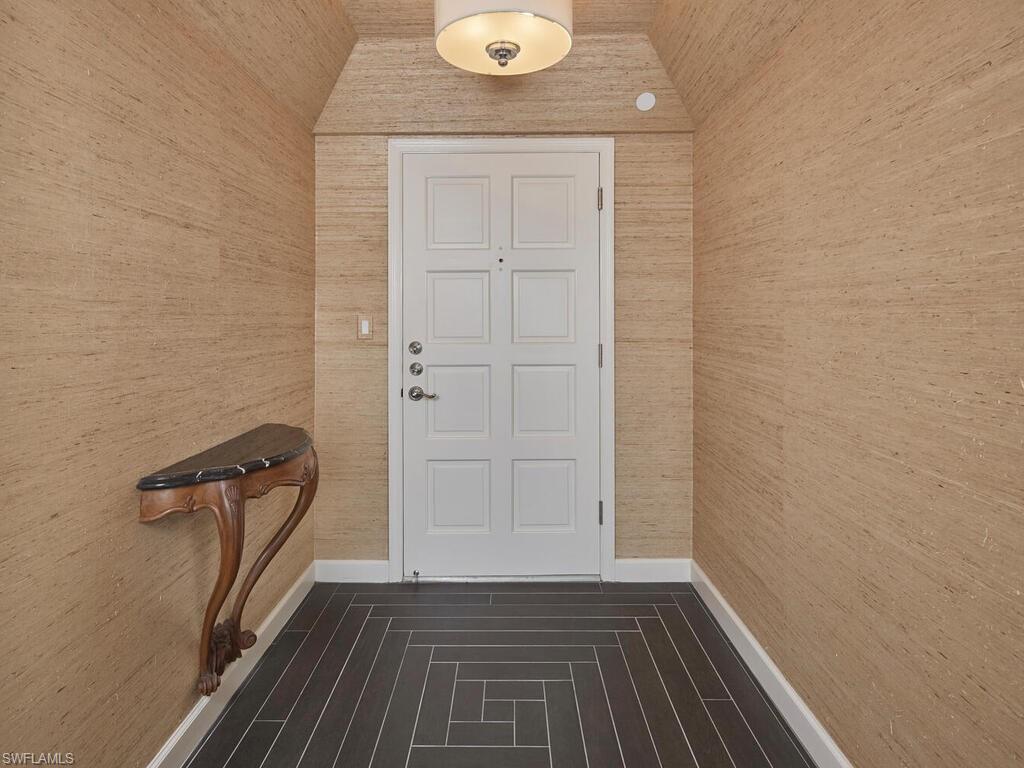 3003 Gulf Shore Boulevard North, Unit 604 Naples, FL 34103 - Photo 14 of 33 a view of a hallway with wooden floor