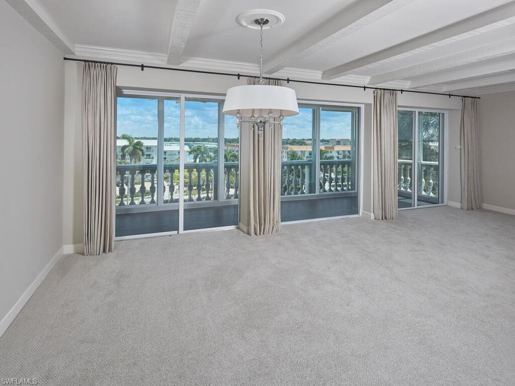 3003 Gulf Shore Boulevard North, Unit 604 Naples, FL 34103 - Photo 19 of 33 a view of an empty room with glass door and balcony
