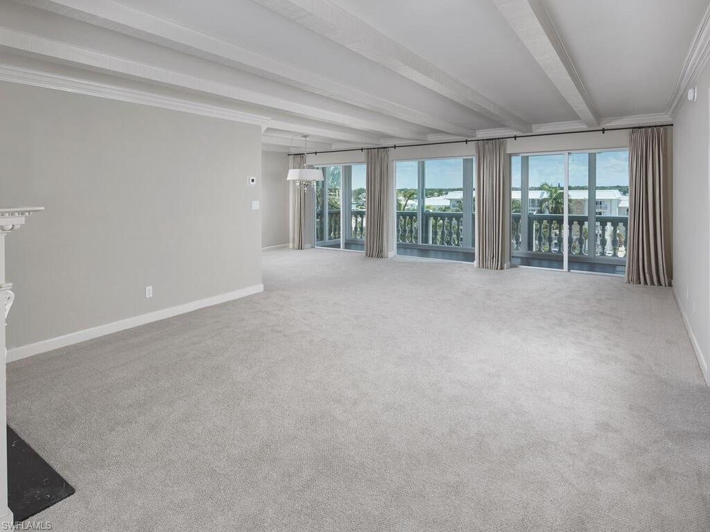 3003 Gulf Shore Boulevard North, Unit 604 Naples, FL 34103 - Photo 20 of 33 a view of an empty room with windows