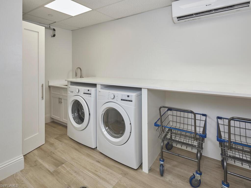 3003 Gulf Shore Boulevard North, Unit 604 Naples, FL 34103 - Photo 24 of 33 a utility room with dryer and washer