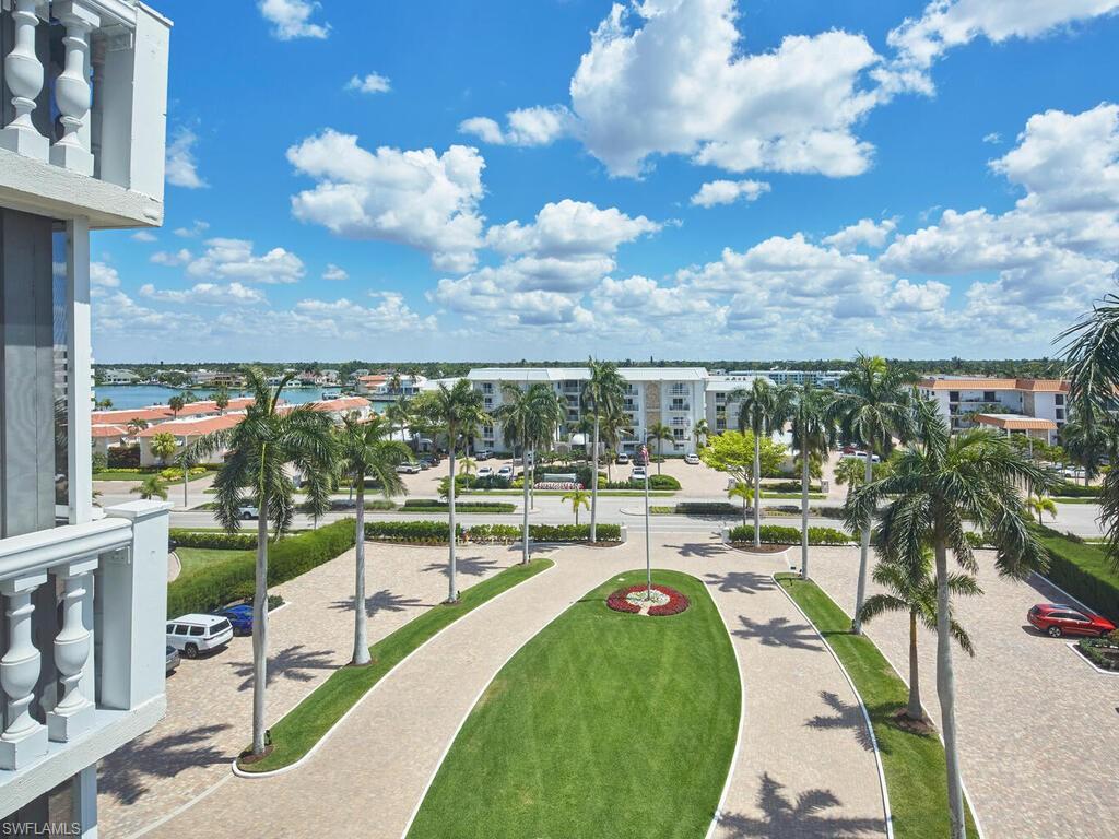 3003 Gulf Shore Boulevard North, Unit 604 Naples, FL 34103 - Photo 26 of 33 a view of a swimming pool and outdoor seating