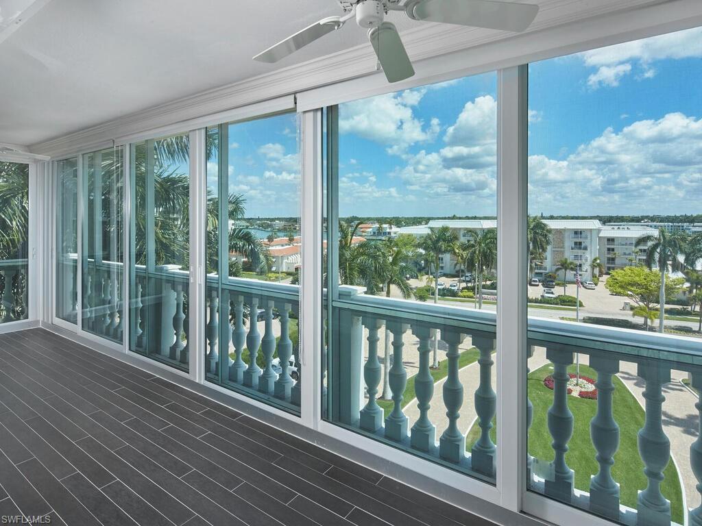 3003 Gulf Shore Boulevard North, Unit 604 Naples, FL 34103 - Photo 3 of 33 a view of a glass door with a balcony