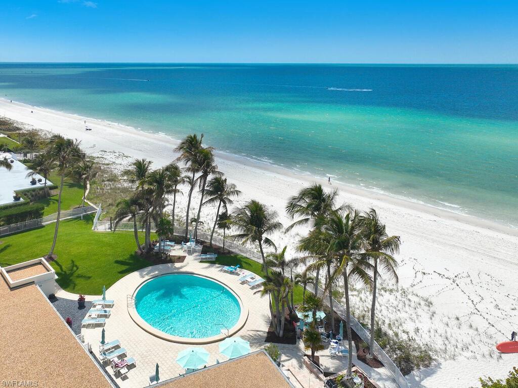 3003 Gulf Shore Boulevard North, Unit 604 Naples, FL 34103 - Photo 32 of 33 a view of a swimming pool with a yard