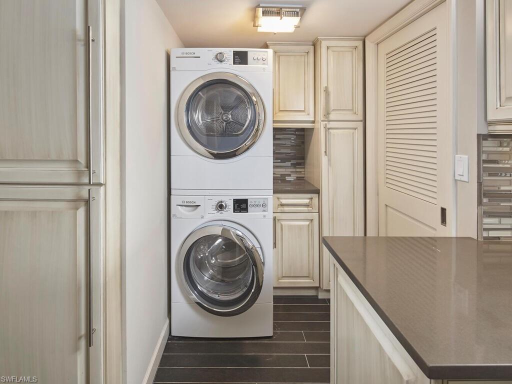 3003 Gulf Shore Boulevard North, Unit 604 Naples, FL 34103 - Photo 8 of 33 a view of a hallway with washer and dryer