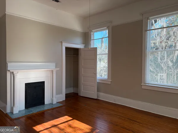 a view of a livingroom with a fireplace and window