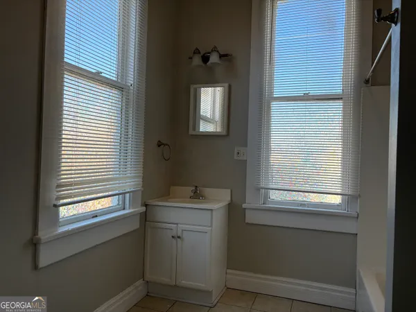 a bathroom with a window and a shower