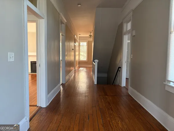 a view of a hallway with wooden floor