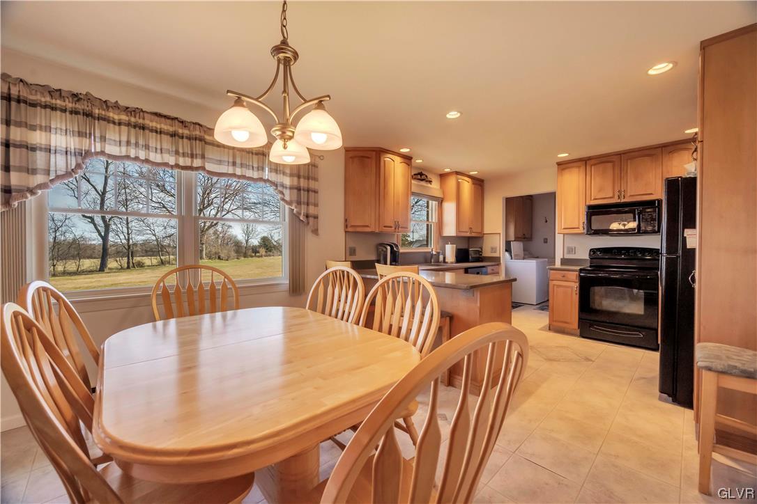255 Filetown Road Nazareth, PA 18064 - Photo 15 of 29 a kitchen with stainless steel appliances granite countertop a sink a stove a dining table and chairs with wooden floor