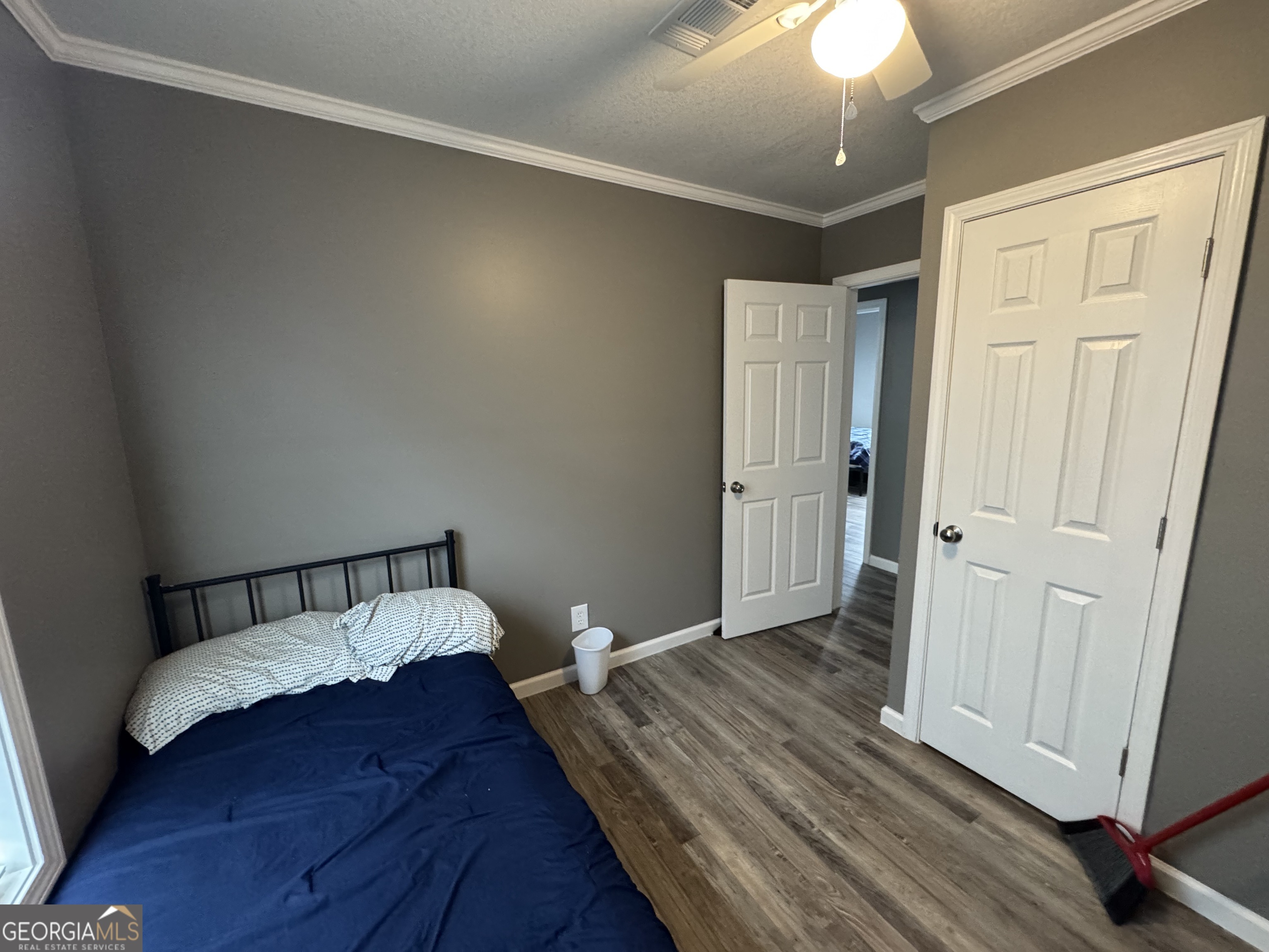10 Grove Street Hazlehurst, GA 31539 - Photo 11 of 15 a bedroom with a bed and wooden floor