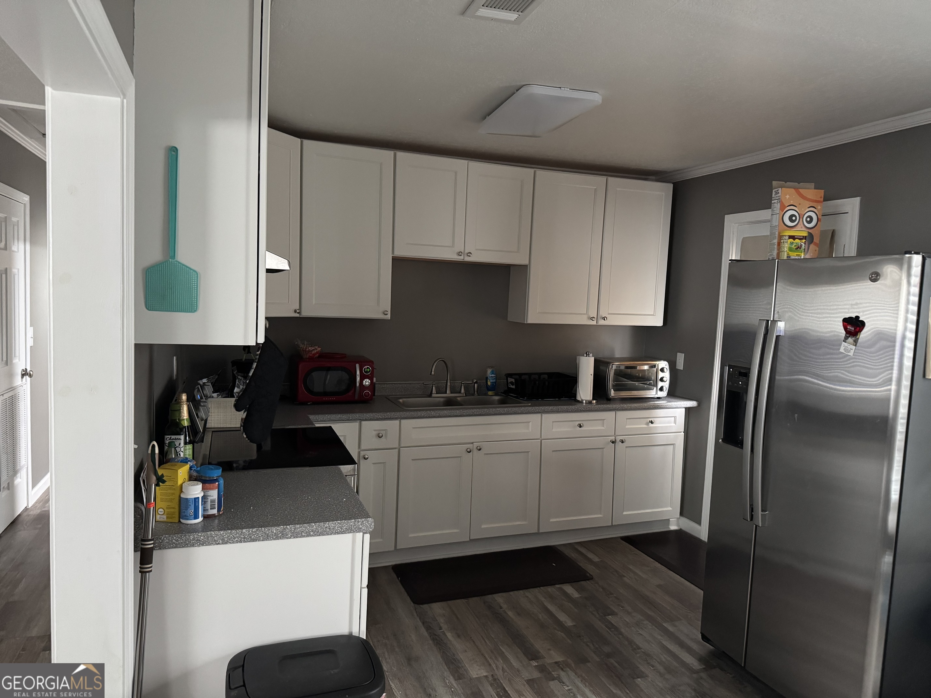 10 Grove Street Hazlehurst, GA 31539 - Photo 4 of 15 a kitchen with a refrigerator and a stove top oven
