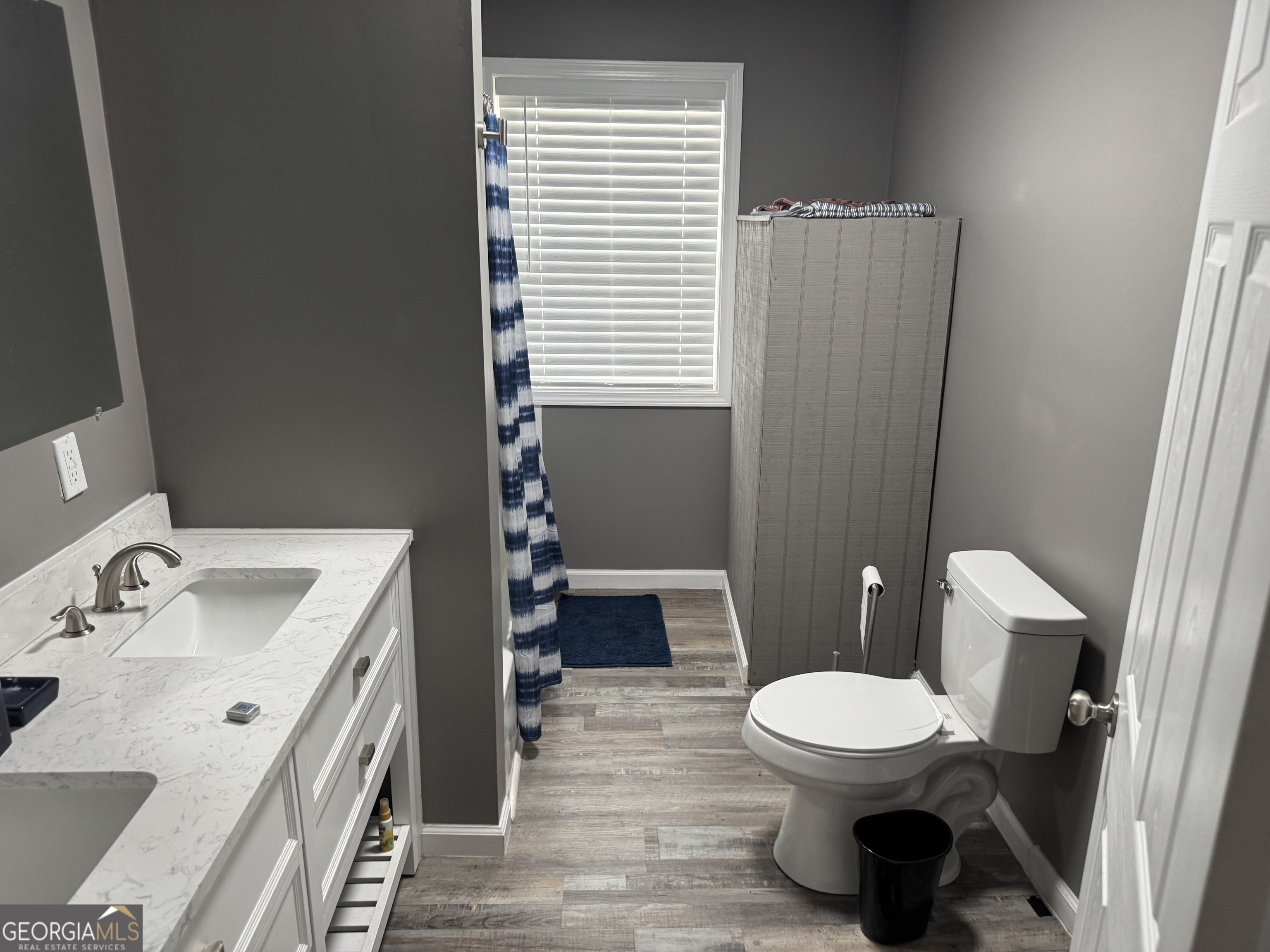 10 Grove Street Hazlehurst, GA 31539 - Photo 7 of 15 a bathroom with a sink a toilet and tub