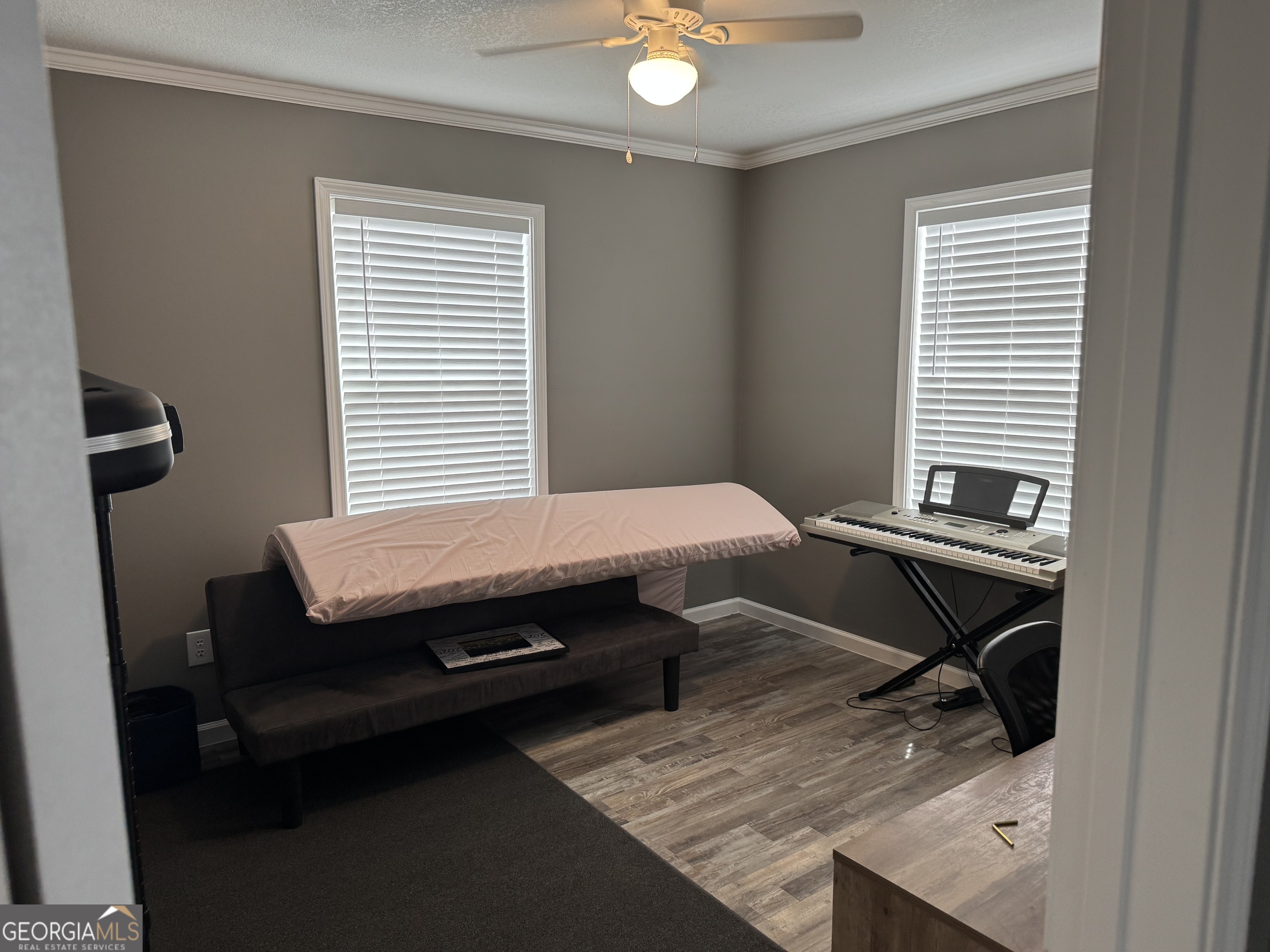 10 Grove Street Hazlehurst, GA 31539 - Photo 9 of 15 a bedroom with a bed and wooden floor