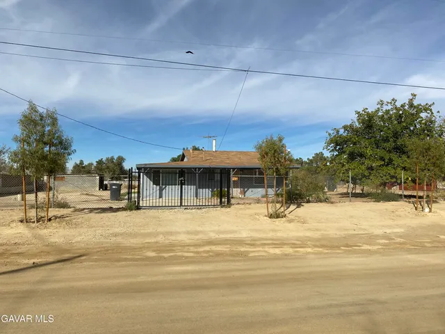 a kitchen with stainless steel appliances a sink a refrigerator and cabinets