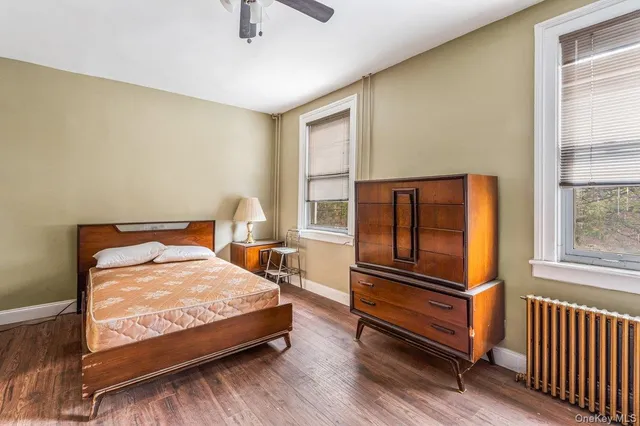 a bedroom with a bed and windows