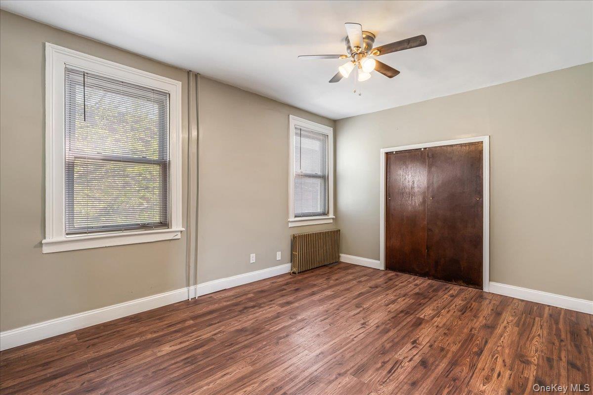 57-39 57th Road Queens, NY 11378 - Photo 11 of 31 a view of empty room with wooden floor and fan