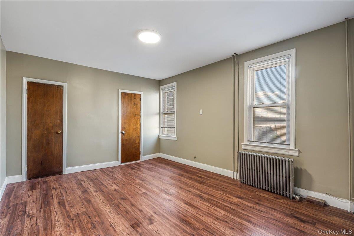 57-39 57th Road Queens, NY 11378 - Photo 12 of 31 a view of a room with wooden floor and windows
