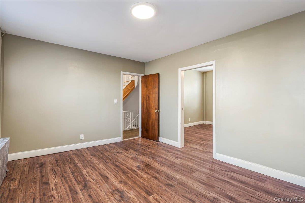 57-39 57th Road Queens, NY 11378 - Photo 13 of 31 a view of an empty room and wooden floor