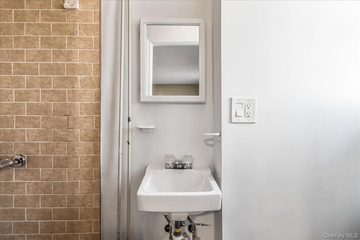 57-39 57th Road Queens, NY 11378 - Photo 14 of 31 a bathroom with a sink and a toilet