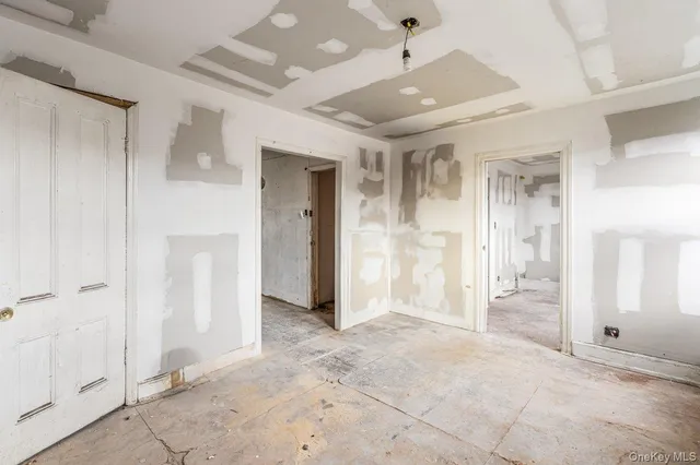 a view of a hallway with wooden shelves