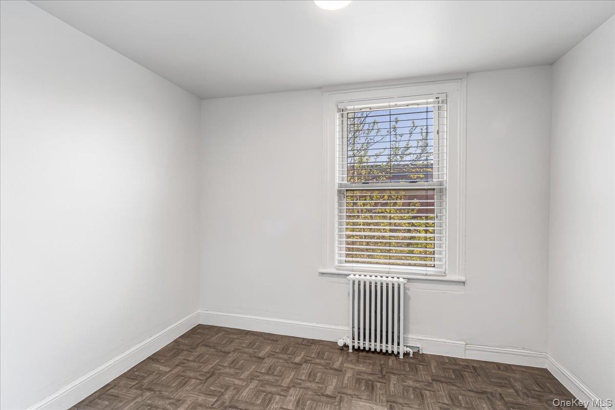 57-39 57th Road Queens, NY 11378 - Photo 16 of 31 an empty room with a window