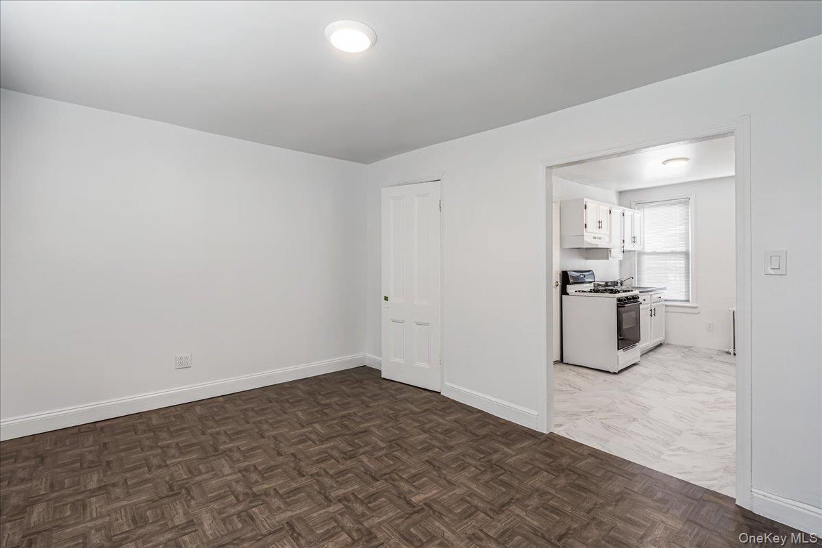 57-39 57th Road Queens, NY 11378 - Photo 17 of 31 a room with a white bed and cabinets