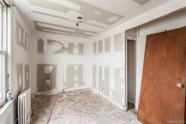 a view of a hallway with wooden walls and door