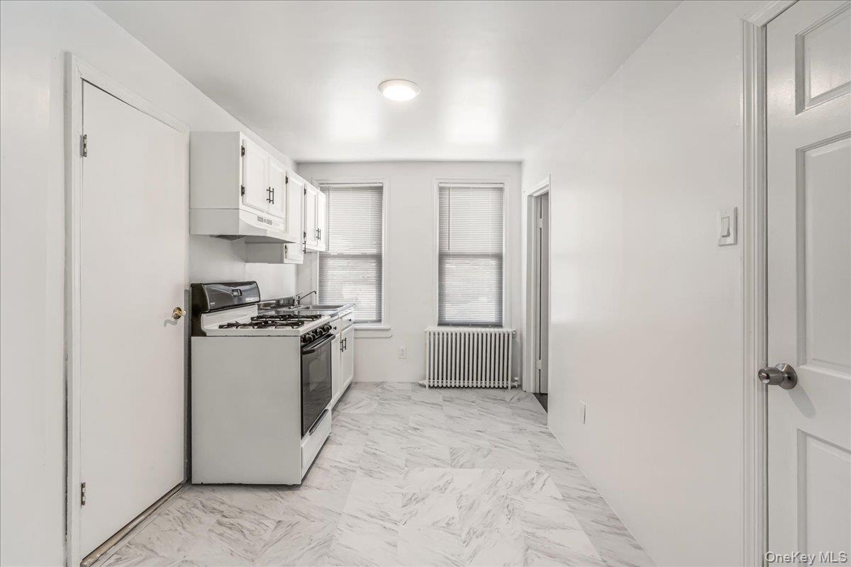 57-39 57th Road Queens, NY 11378 - Photo 20 of 31 a kitchen with stainless steel appliances granite countertop a stove a sink and a refrigerator