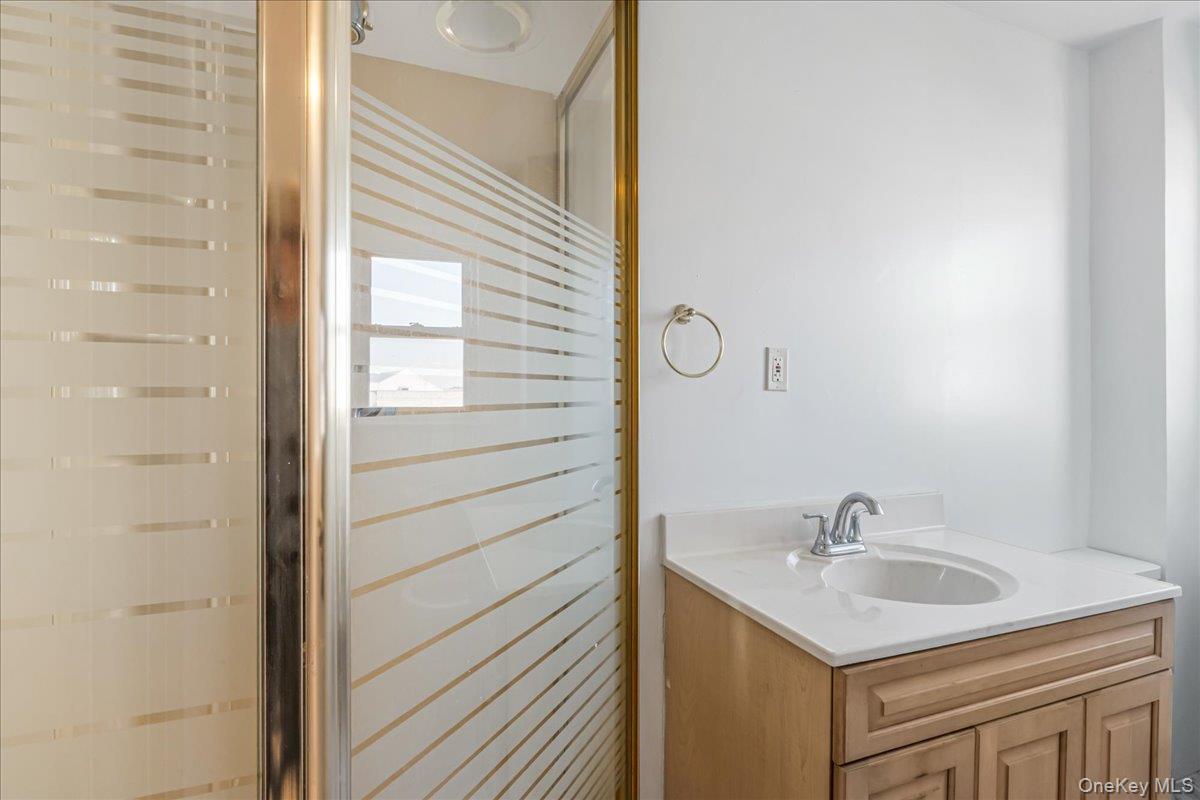 57-39 57th Road Queens, NY 11378 - Photo 23 of 31 a bathroom with a sink and a mirror