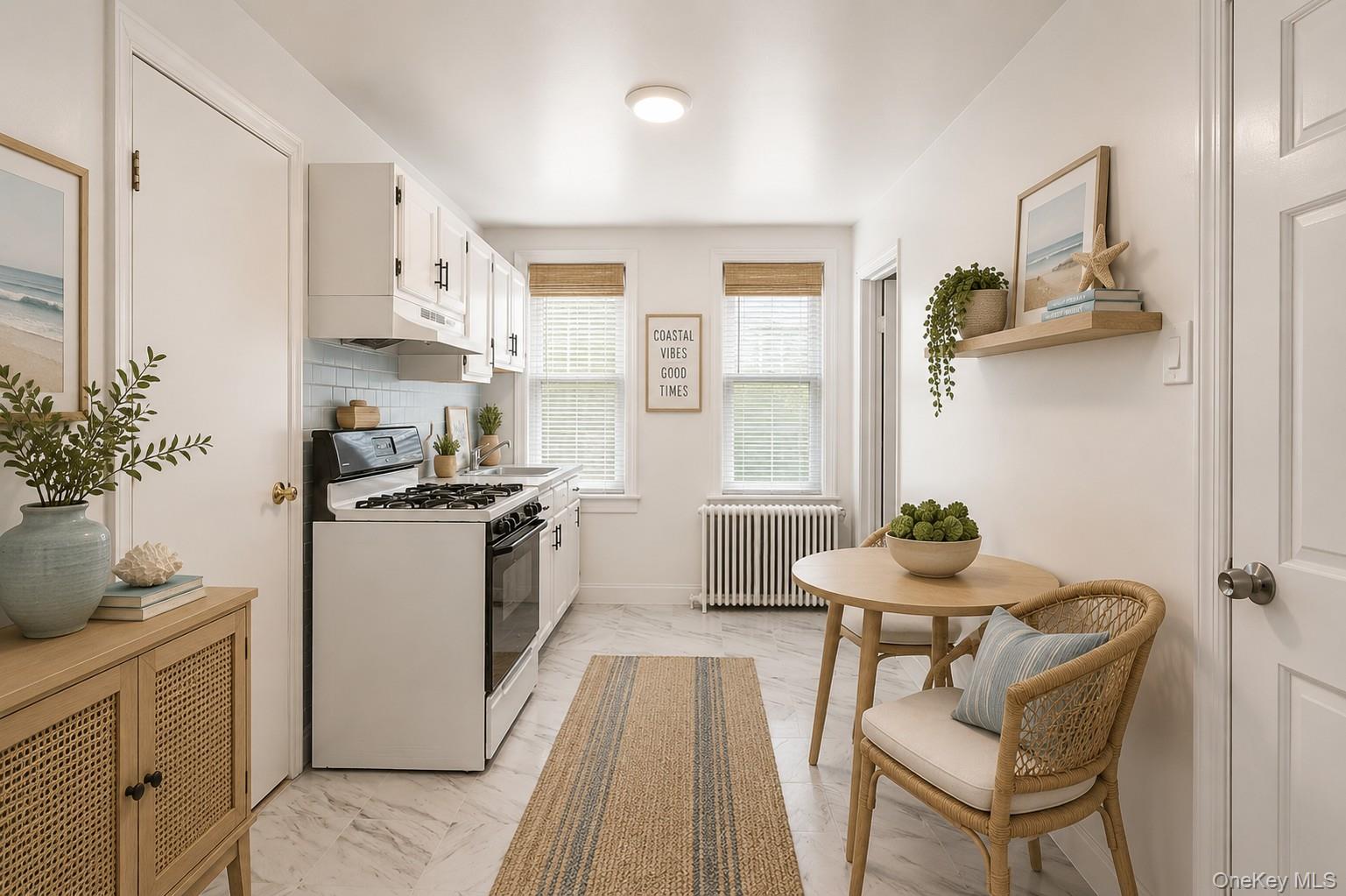 57-39 57th Road Queens, NY 11378 - Photo 7 of 31 a kitchen with stainless steel appliances kitchen island a table and chairs in it