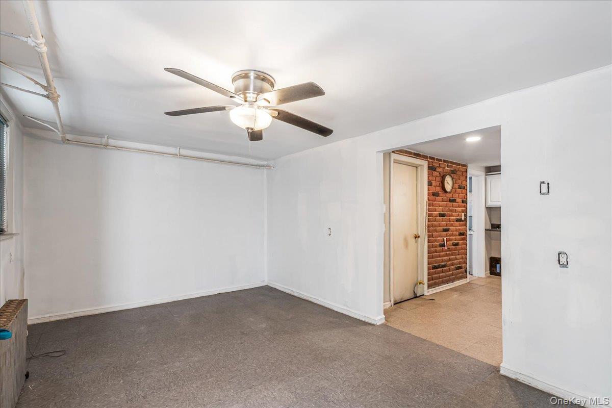 57-39 57th Road Queens, NY 11378 - Photo 9 of 31 an empty room with closet and a ceiling fan