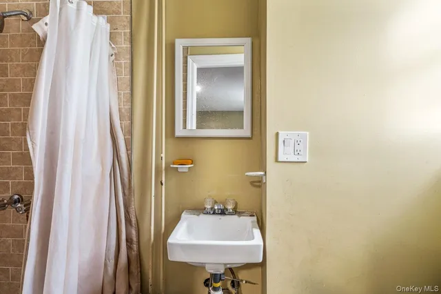 a bathroom with a sink and mirror