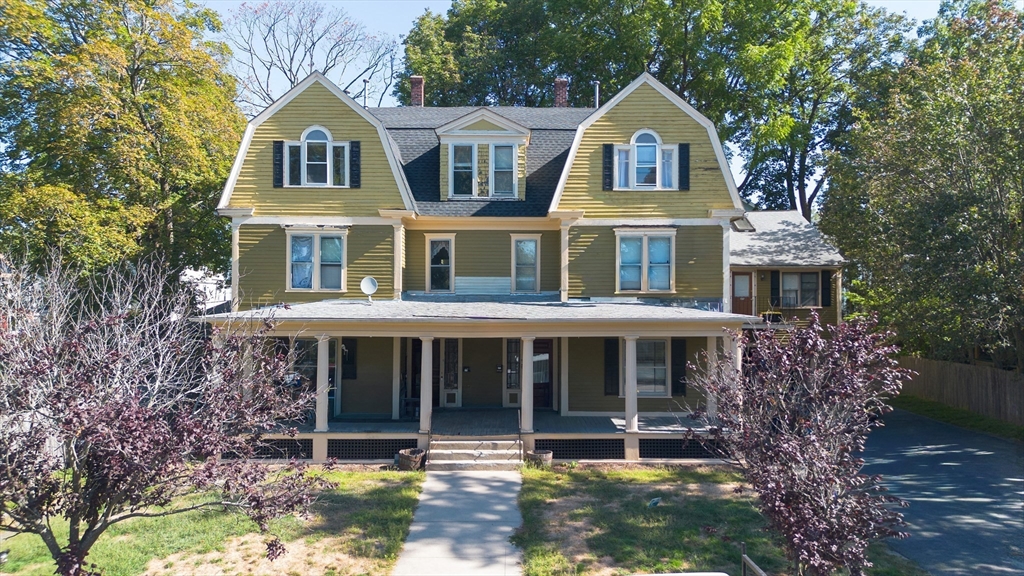 35 Tirrell Street, Unit 3 Worcester, MA 01603 - Photo 1 of 9 a front view of a house with a yard and trees