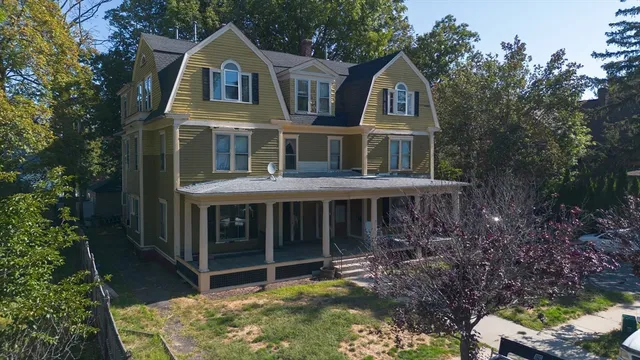 a front view of a house with a garden