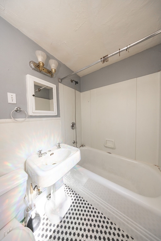 35 Tirrell Street, Unit 3 Worcester, MA 01603 - Photo 5 of 9 a bathroom with a sink a toilet and shower