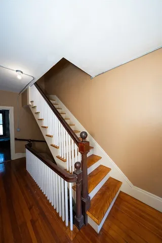 a view of a room with wooden floor