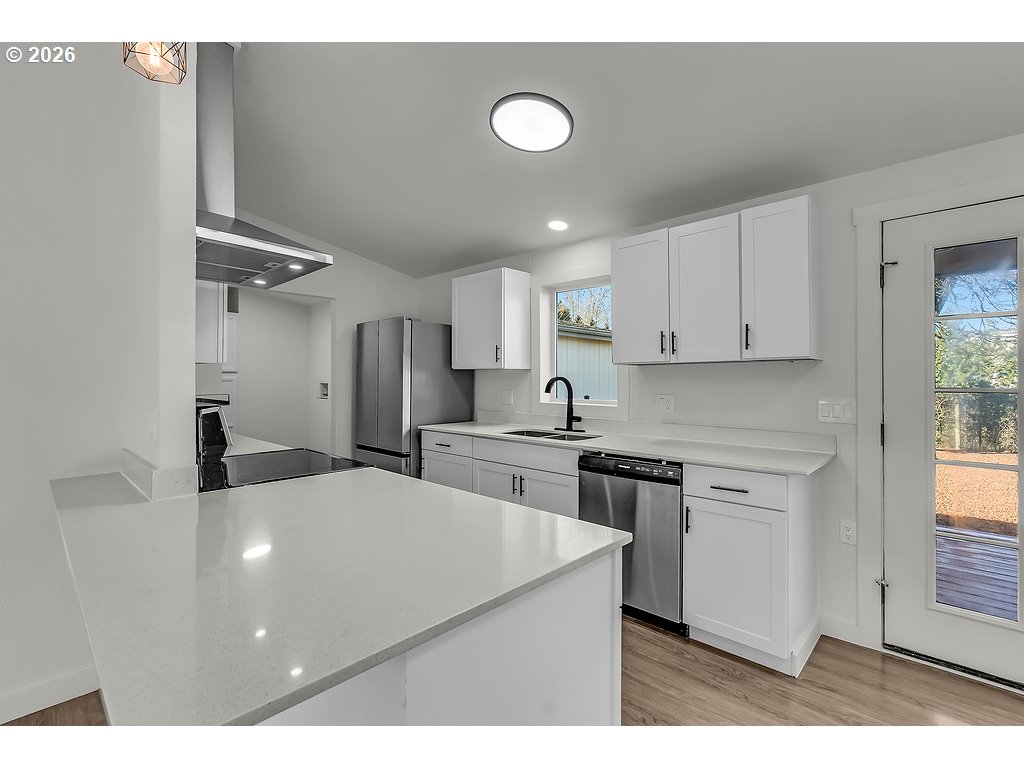 1477 June Way Woodburn, OR 97071 - Photo 11 of 34 a kitchen with stainless steel appliances a refrigerator sink and cabinets