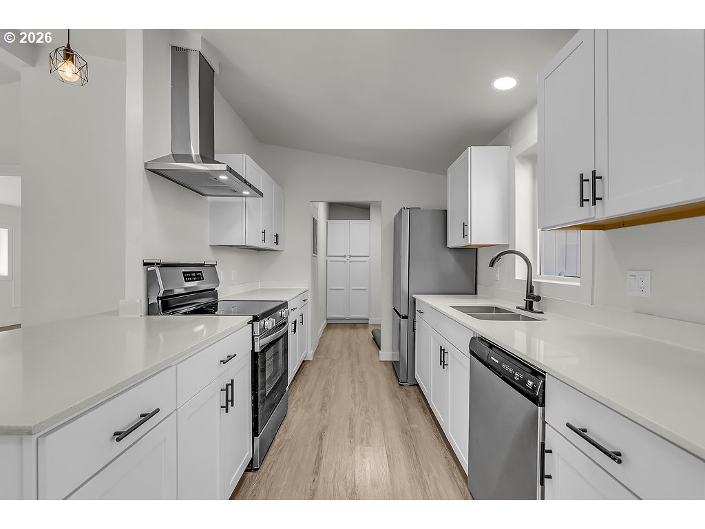 1477 June Way Woodburn, OR 97071 - Photo 16 of 34 a kitchen with granite countertop a sink stainless steel appliances and cabinets