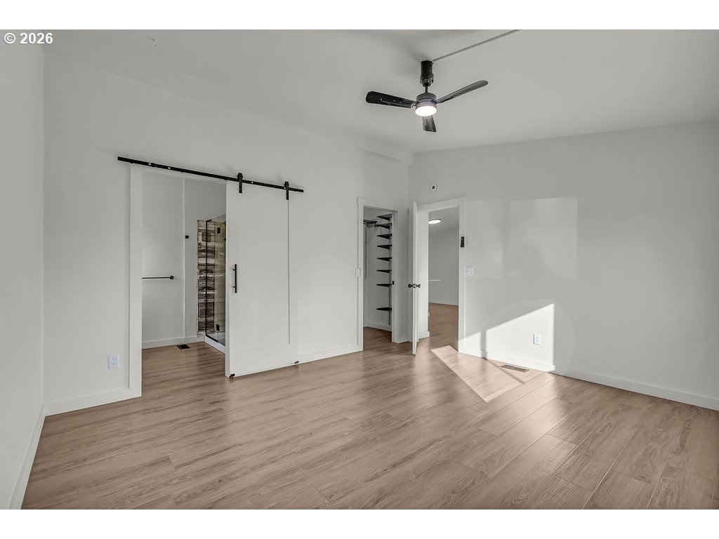 1477 June Way Woodburn, OR 97071 - Photo 20 of 34 a view of an empty room with wooden floor