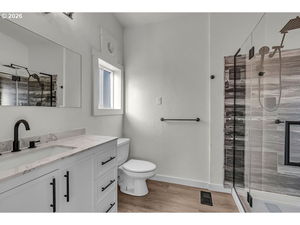 1477 June Way Woodburn, OR 97071 - Photo 21 of 34 a bathroom with a granite countertop sink toilet and shower