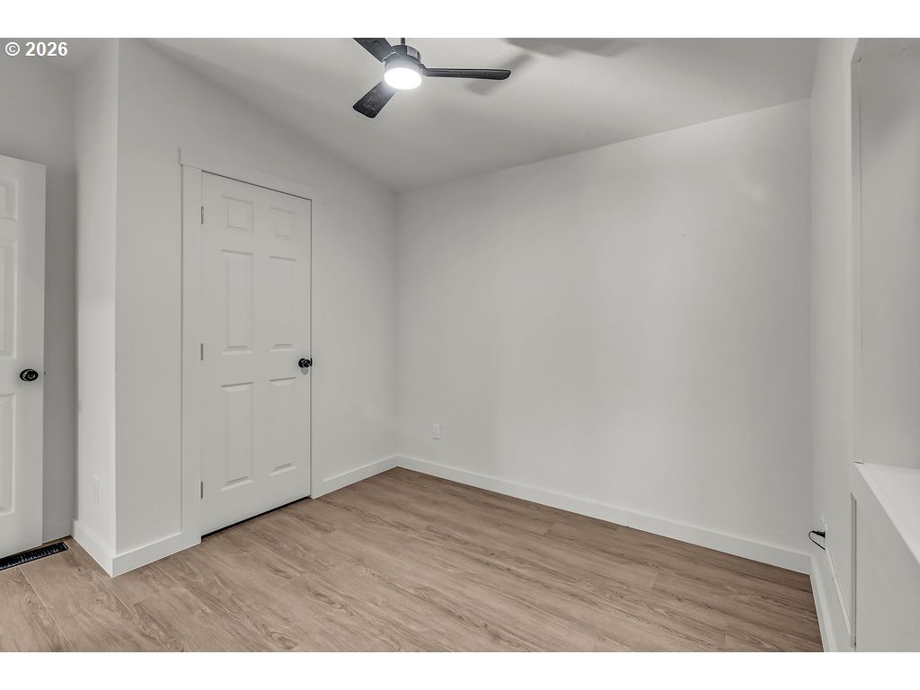 1477 June Way Woodburn, OR 97071 - Photo 26 of 34 a view of an empty room with wooden floor