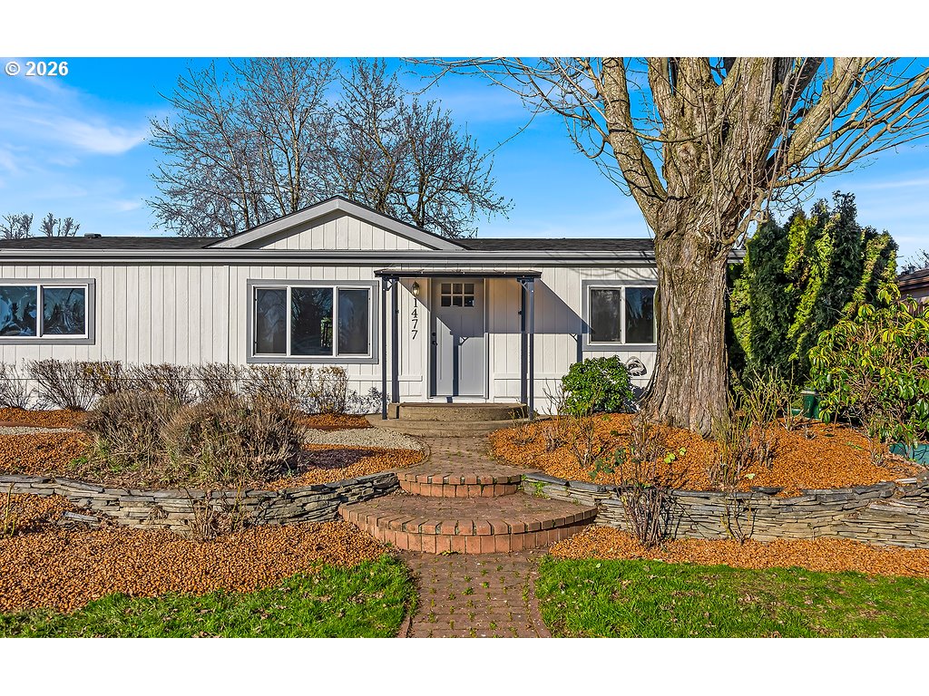 1477 June Way Woodburn, OR 97071 - Photo 3 of 34 a front view of a house with garden