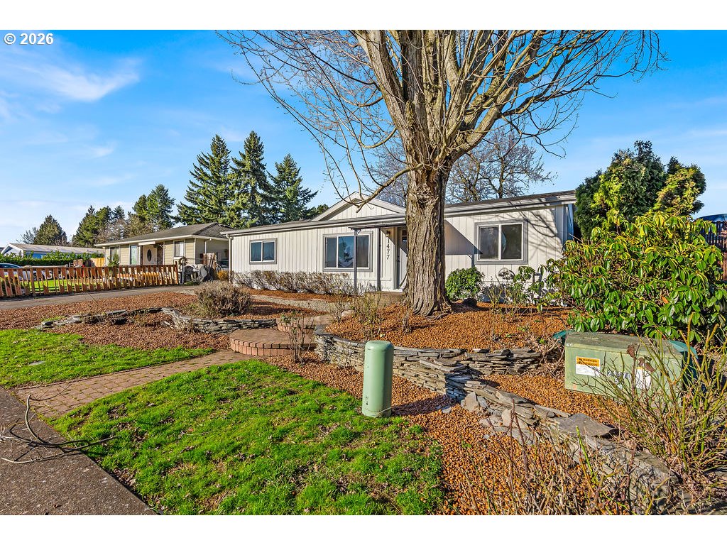 1477 June Way Woodburn, OR 97071 - Photo 4 of 34 a house view with a garden space