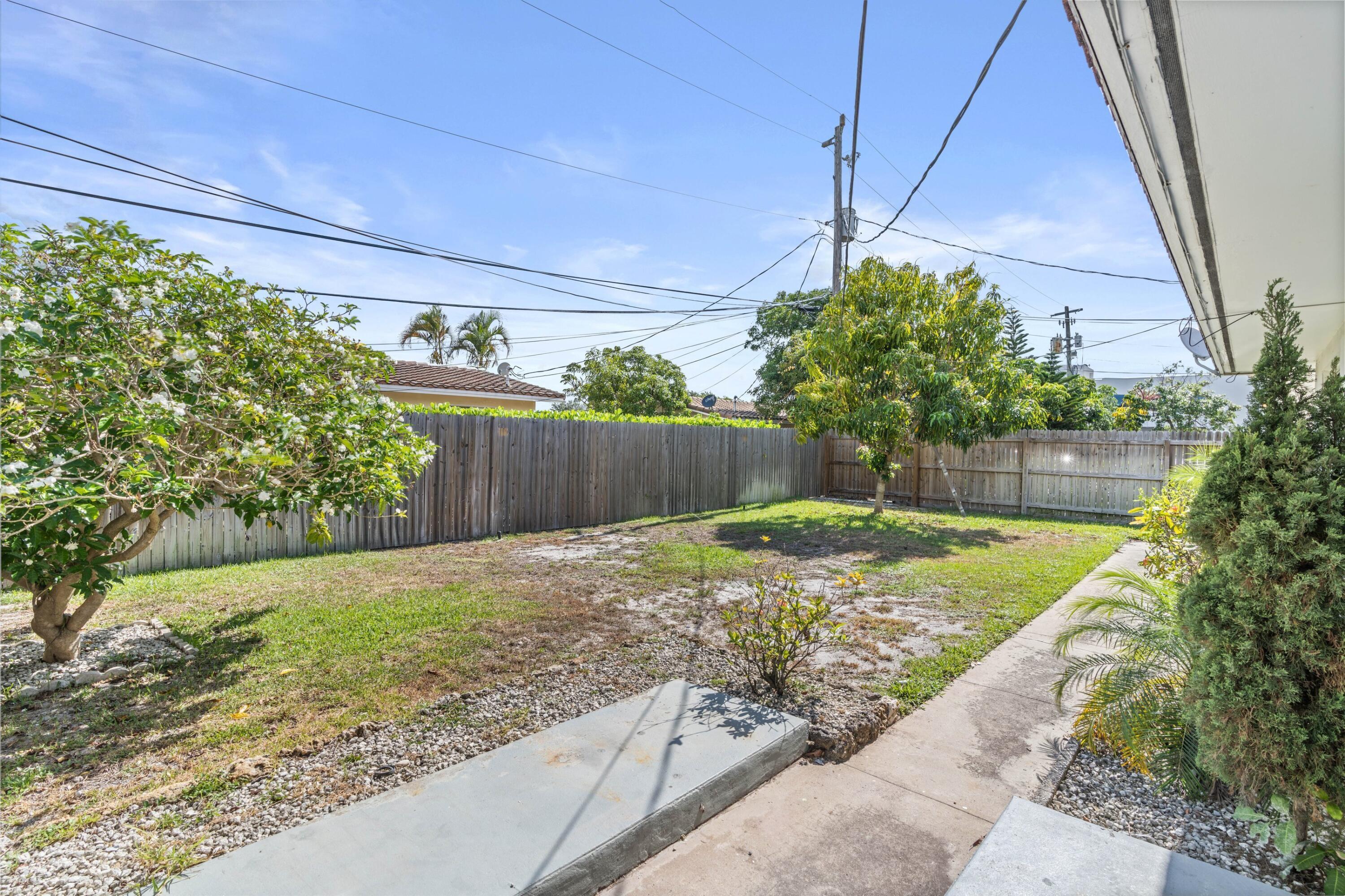541 Northeast 44th Street, Unit C Boca Raton, FL 33431 - Photo 13 of 16 a view of a backyard with plants