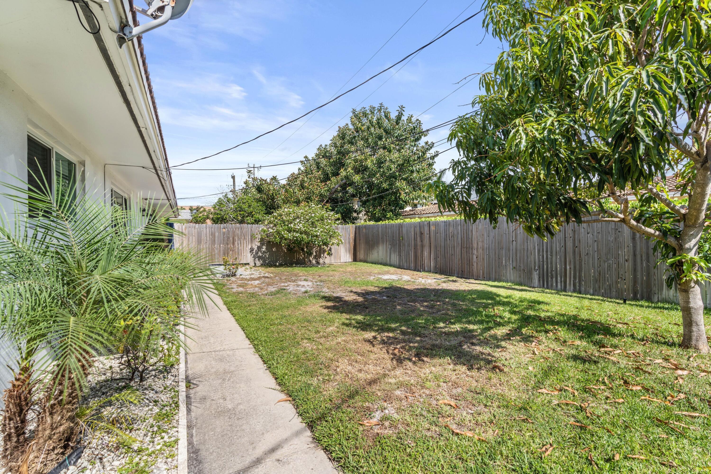 541 Northeast 44th Street, Unit C Boca Raton, FL 33431 - Photo 14 of 16 a view of a backyard with pathway