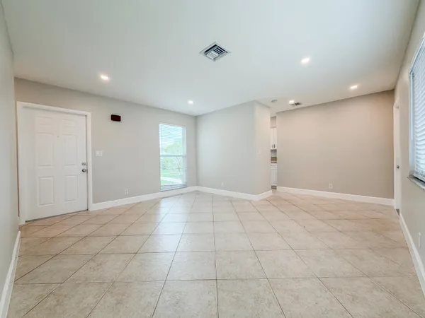 a view of a house with a yard and potted plants