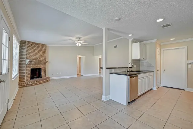 a kitchen with stainless steel appliances granite countertop a stove top oven a sink and a refrigerator